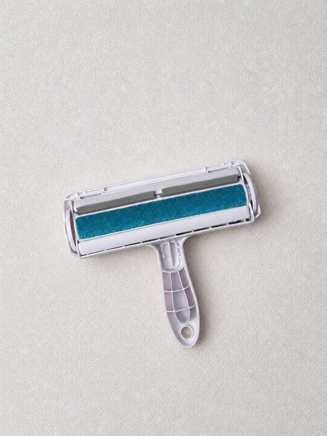 Open pet hair roller showing its collection chamber